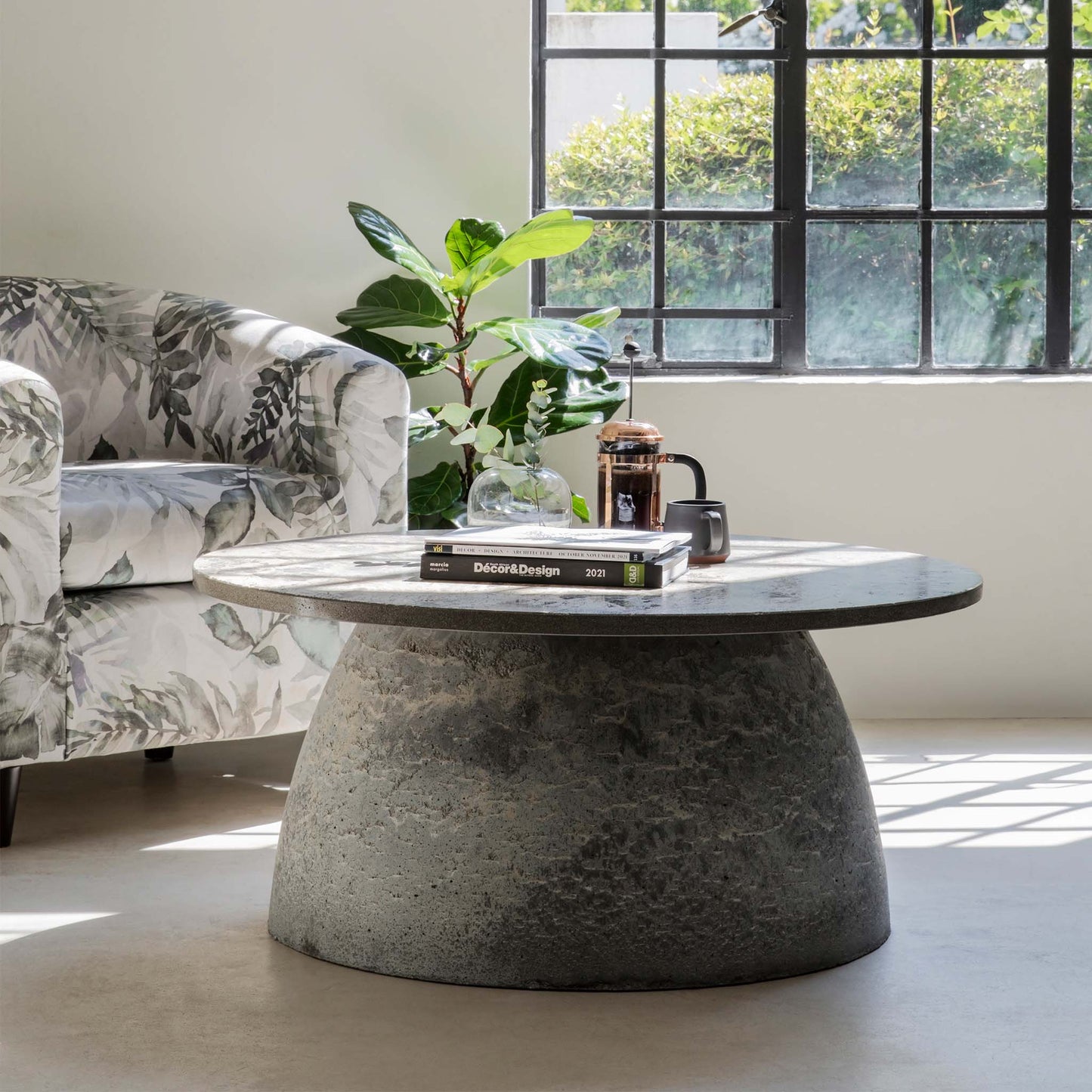 Rotunda Coffee Table in a room with books on top